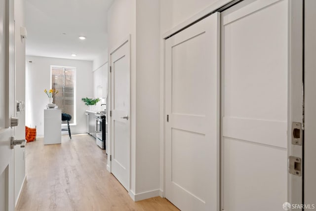 hallway with recessed lighting and light wood-style flooring