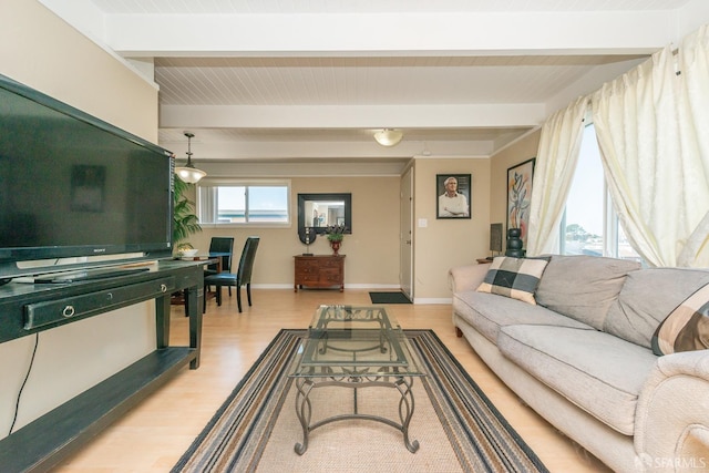 living room with beam ceiling and light wood-type flooring