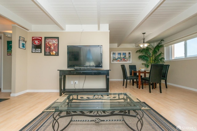 living room with beamed ceiling and light hardwood / wood-style flooring