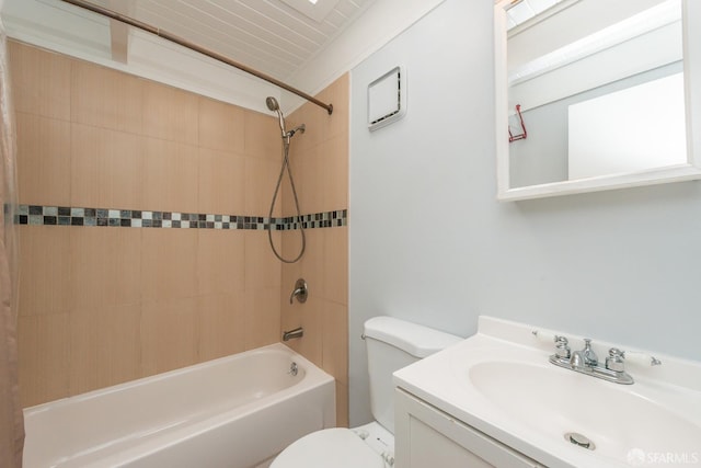 full bathroom featuring ornamental molding, vanity, tiled shower / bath combo, and toilet