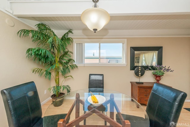 dining space with wood-type flooring and beam ceiling