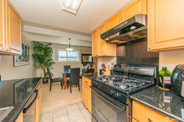 kitchen with black gas range, light brown cabinets, dark stone counters, and hanging light fixtures