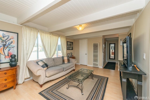 living room featuring light wood-type flooring and beamed ceiling