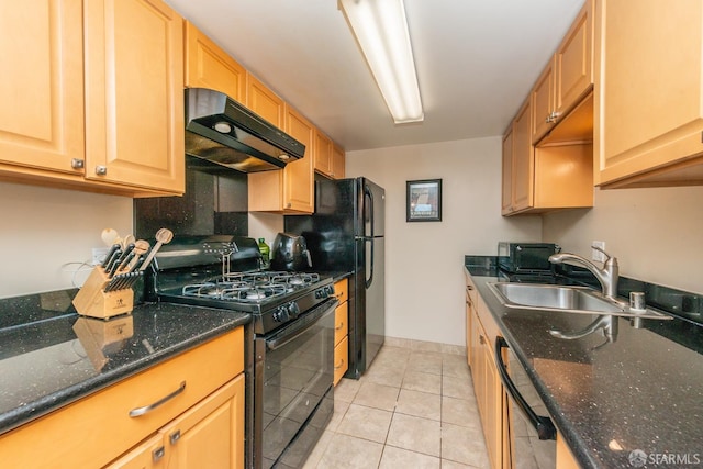 kitchen featuring black appliances, sink, dark stone counters, and light tile patterned flooring