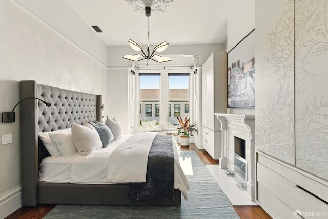 370 Sanchez St, San Francisco, CA 94114 - bedroom featuring a chandelier, access to exterior, dark wood-type flooring, and a fireplace with flush hearth