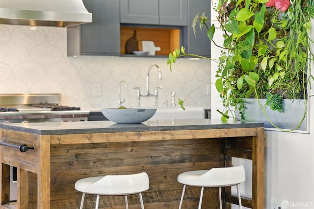 370 Sanchez St, San Francisco, CA 94114 - kitchen featuring wall chimney range hood, range with gas stovetop, and backsplash