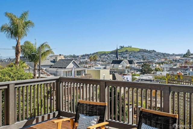 deck with a residential view and a mountain view