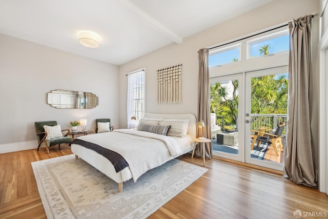 bedroom with access to exterior, french doors, wood finished floors, beamed ceiling, and baseboards