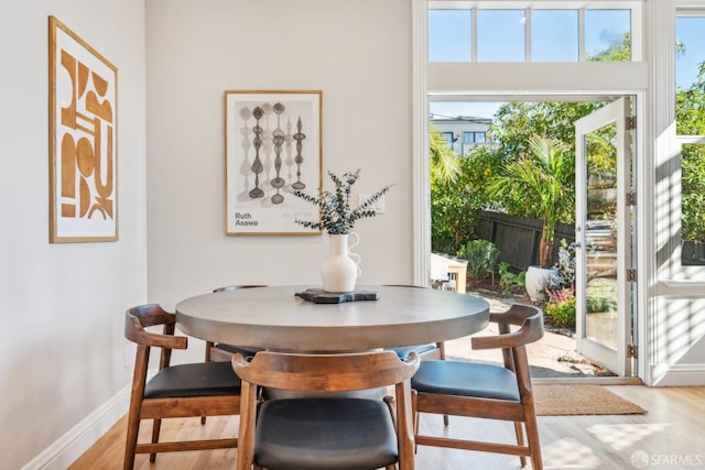 dining area featuring wood finished floors and baseboards