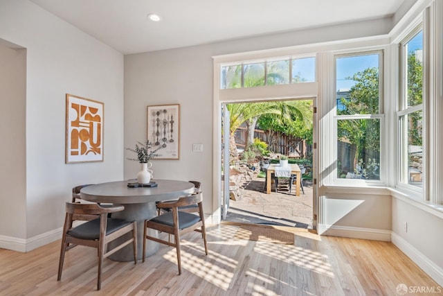 dining area with baseboards, recessed lighting, and light wood-style floors