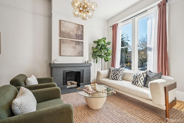 living area featuring a fireplace and a notable chandelier