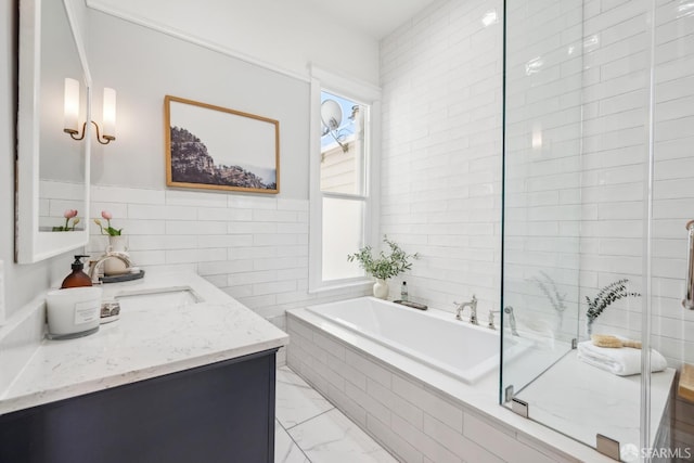 bathroom with vanity, tile walls, marble finish floor, a bath, and an enclosed shower