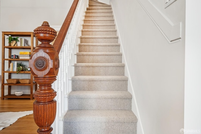 staircase featuring wood finished floors