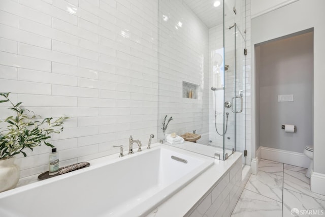 bathroom featuring a garden tub, toilet, baseboards, marble finish floor, and a shower stall