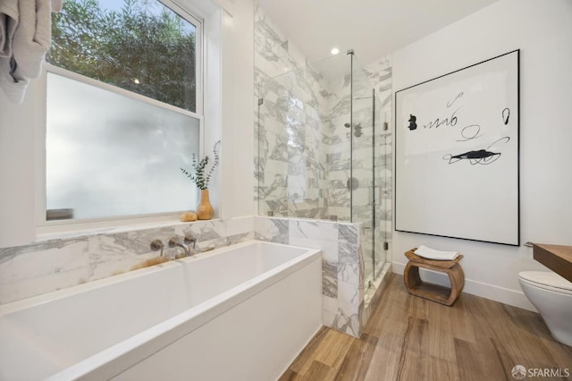 bathroom with hardwood / wood-style flooring, toilet, and independent shower and bath