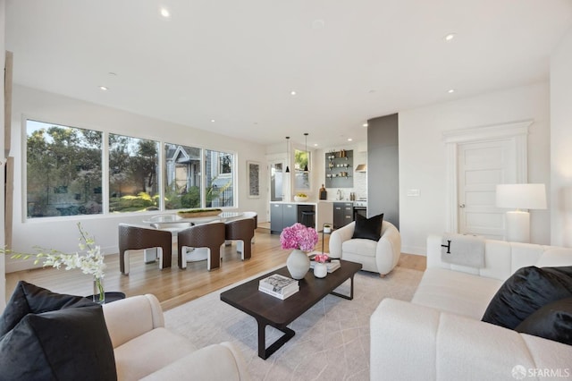 living room with light wood-type flooring and sink