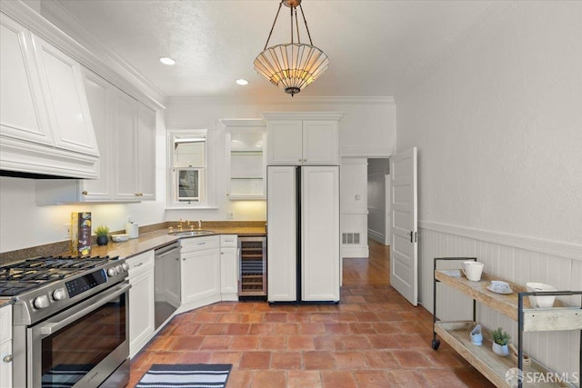 787 Arguello Blvd, San Francisco, CA 94118 - kitchen featuring stainless steel appliances, wine cooler, a sink, white cabinets, and wainscoting