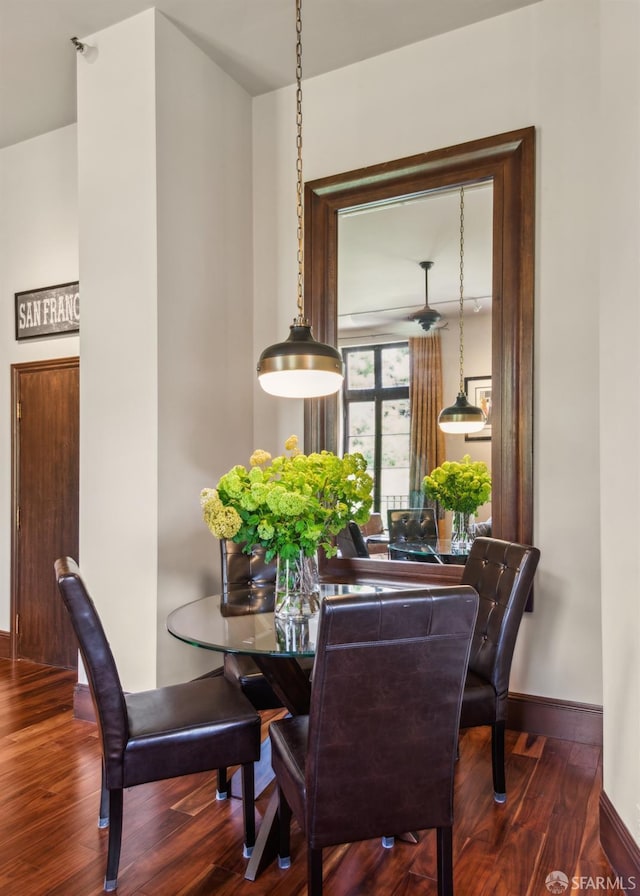 dining space with wood finished floors and baseboards