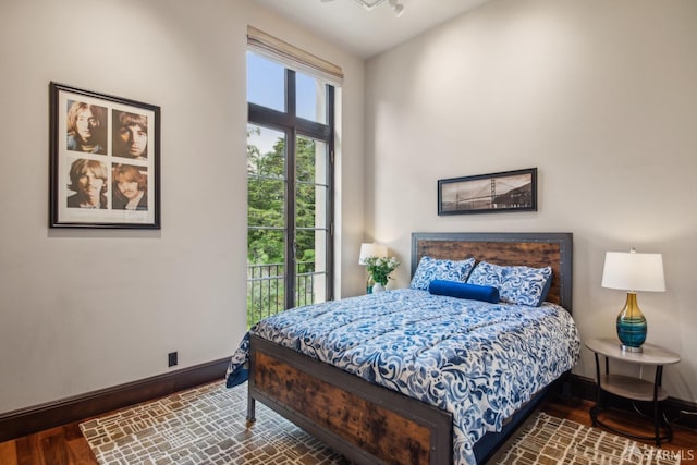 bedroom featuring wood finished floors and baseboards