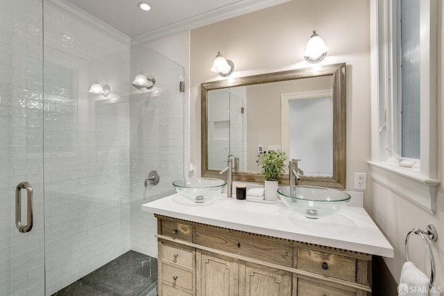 bathroom with crown molding, double vanity, a stall shower, and a sink