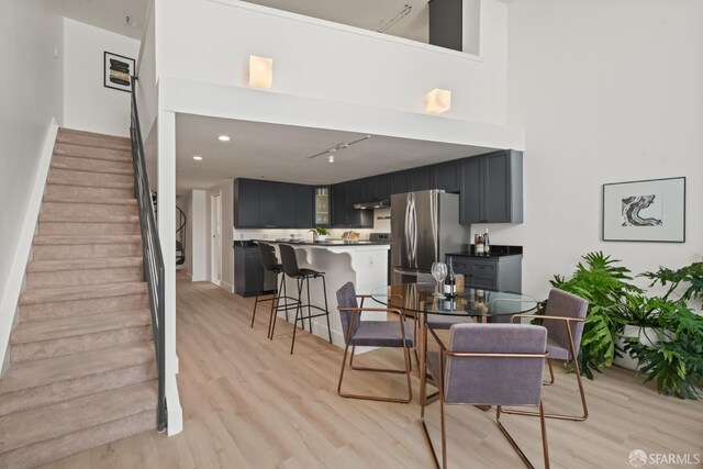39 Boardman Pl Unit 105, San Francisco, CA 94103 - dining room featuring light wood-type flooring, stairway, and rail lighting