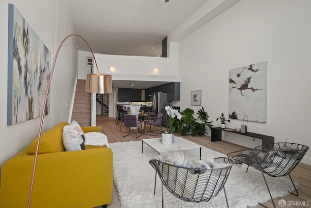 39 Boardman Pl Unit 105, San Francisco, CA 94103 - living room with wood finished floors, stairs, and a high ceiling