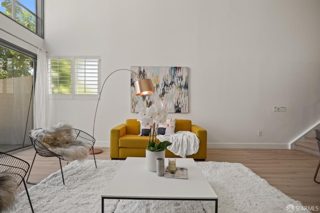 39 Boardman Pl Unit 105, San Francisco, CA 94103 - living area featuring wood finished floors, a high ceiling, and stairway