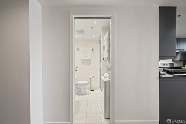 39 Boardman Pl Unit 105, San Francisco, CA 94103 - hallway with estacked washer and dryer and light tile patterned flooring