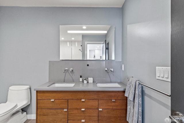 bathroom featuring toilet, decorative backsplash, walk in shower, and vanity