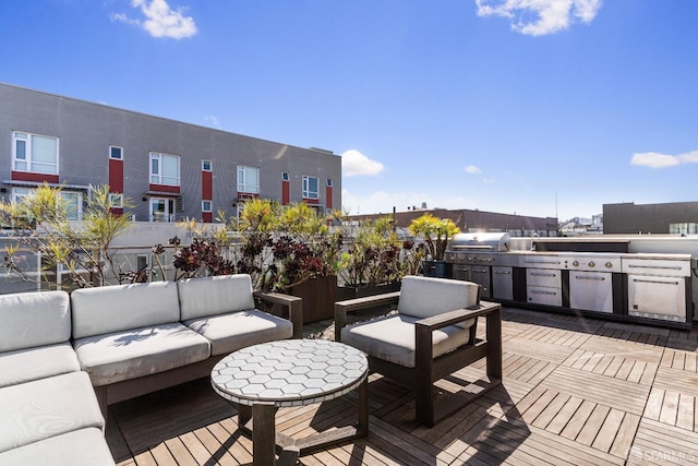 wooden deck featuring an outdoor living space and area for grilling