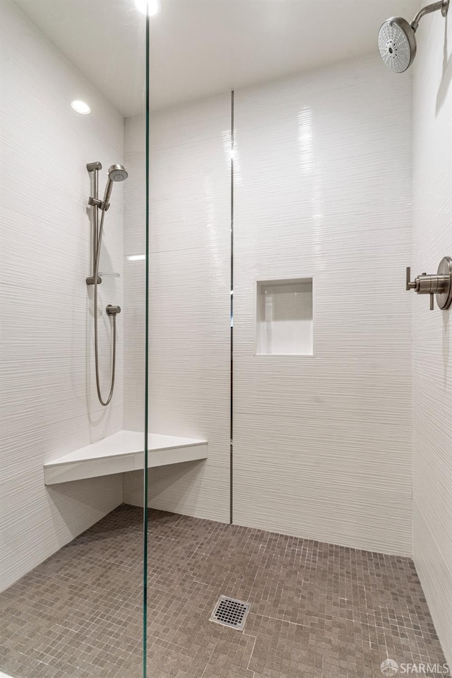 bathroom featuring tile patterned floors and tiled shower