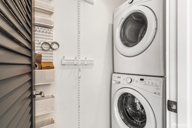 clothes washing area featuring stacked washer / drying machine