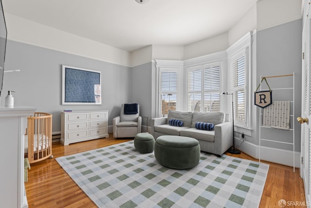 3294 Clay St Unit 6, San Francisco, CA 94123 - living area with light wood-style floors and a baseboard heating unit