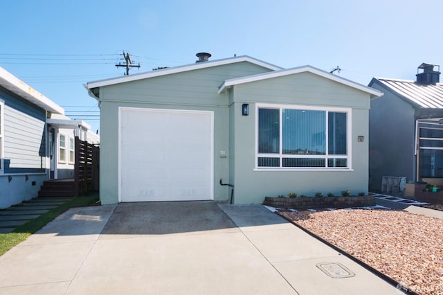 view of front of home with stucco siding, concrete driveway, and a garage