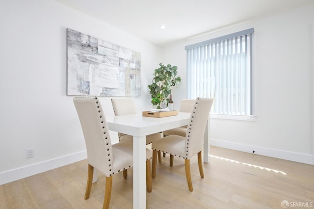 dining space with recessed lighting, wood finished floors, and baseboards