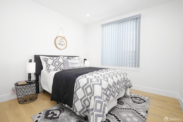 bedroom featuring recessed lighting, wood finished floors, and baseboards