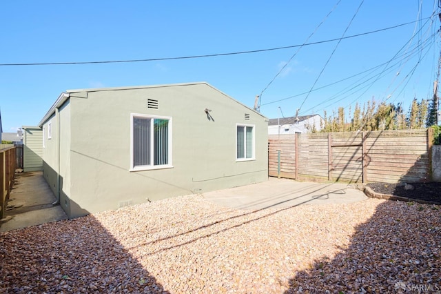 view of property exterior featuring a patio, a fenced backyard, and stucco siding