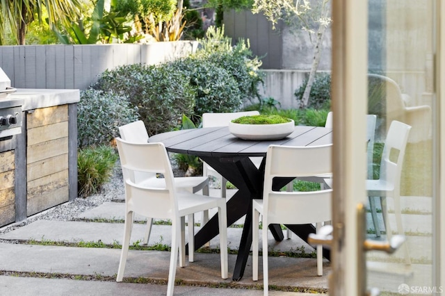 view of patio / terrace with outdoor dining space and fence