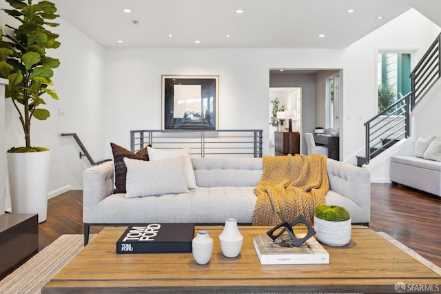 living area featuring stairway, recessed lighting, baseboards, and wood finished floors