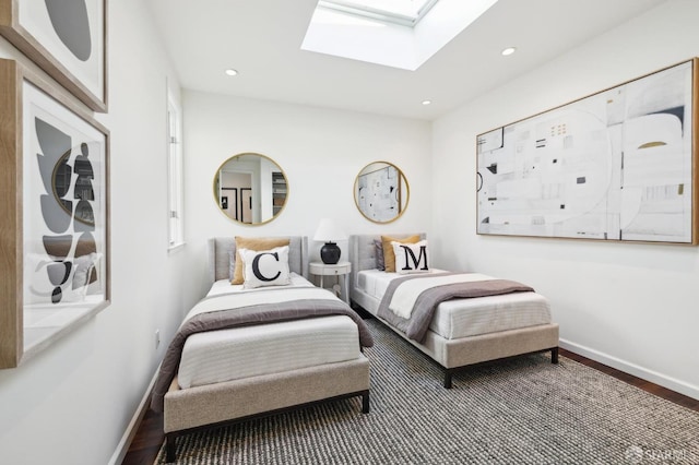 bedroom featuring recessed lighting, baseboards, wood finished floors, and a skylight