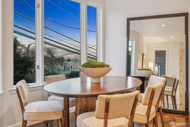 dining area with recessed lighting, a healthy amount of sunlight, baseboards, and wood finished floors