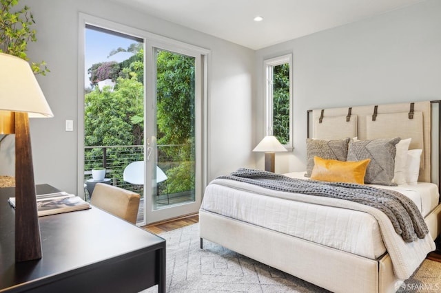 bedroom with recessed lighting, multiple windows, and wood finished floors