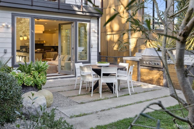 view of patio / terrace with outdoor dining space and a grill