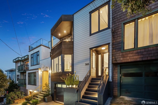 contemporary house with a garage and a balcony