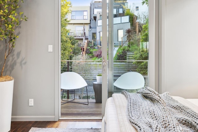 bedroom featuring baseboards and wood finished floors