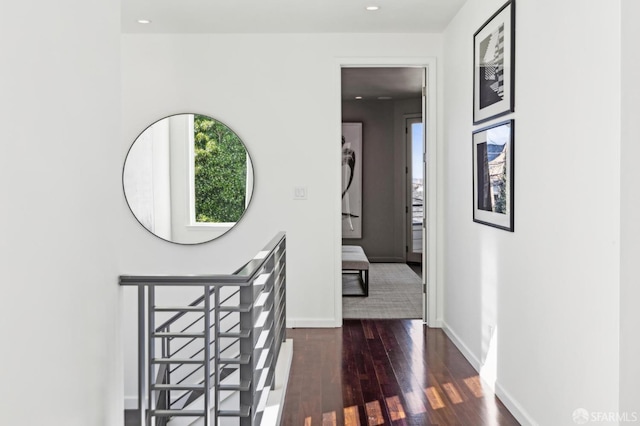 hall featuring recessed lighting, wood finished floors, and baseboards