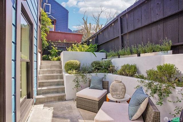 view of patio / terrace with stairs and fence