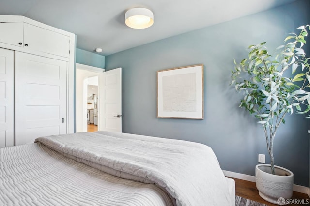 bedroom with baseboards and wood finished floors