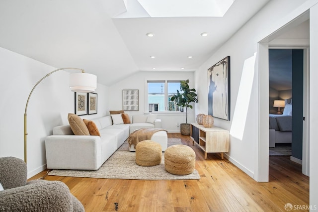 living room with recessed lighting, baseboards, and light wood finished floors