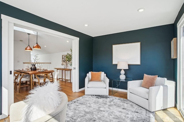 living area with recessed lighting, wood finished floors, and baseboards